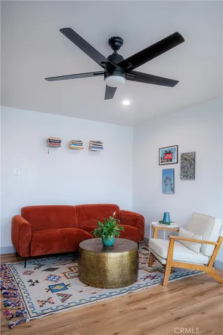 a living room with furniture and a potted plant