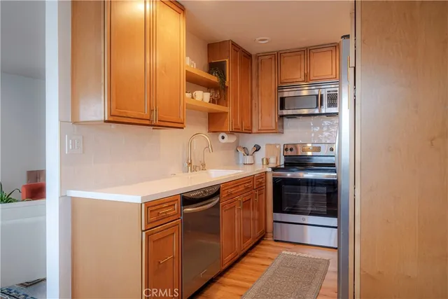 a kitchen with stainless steel appliances granite countertop a sink and cabinets