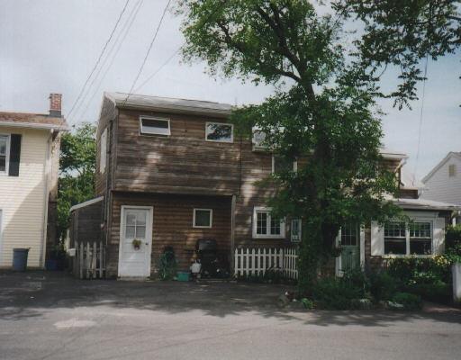 17 Milford Point Road Milford, CT 06460 - Photo 1 of 1 a front view of a house with a yard