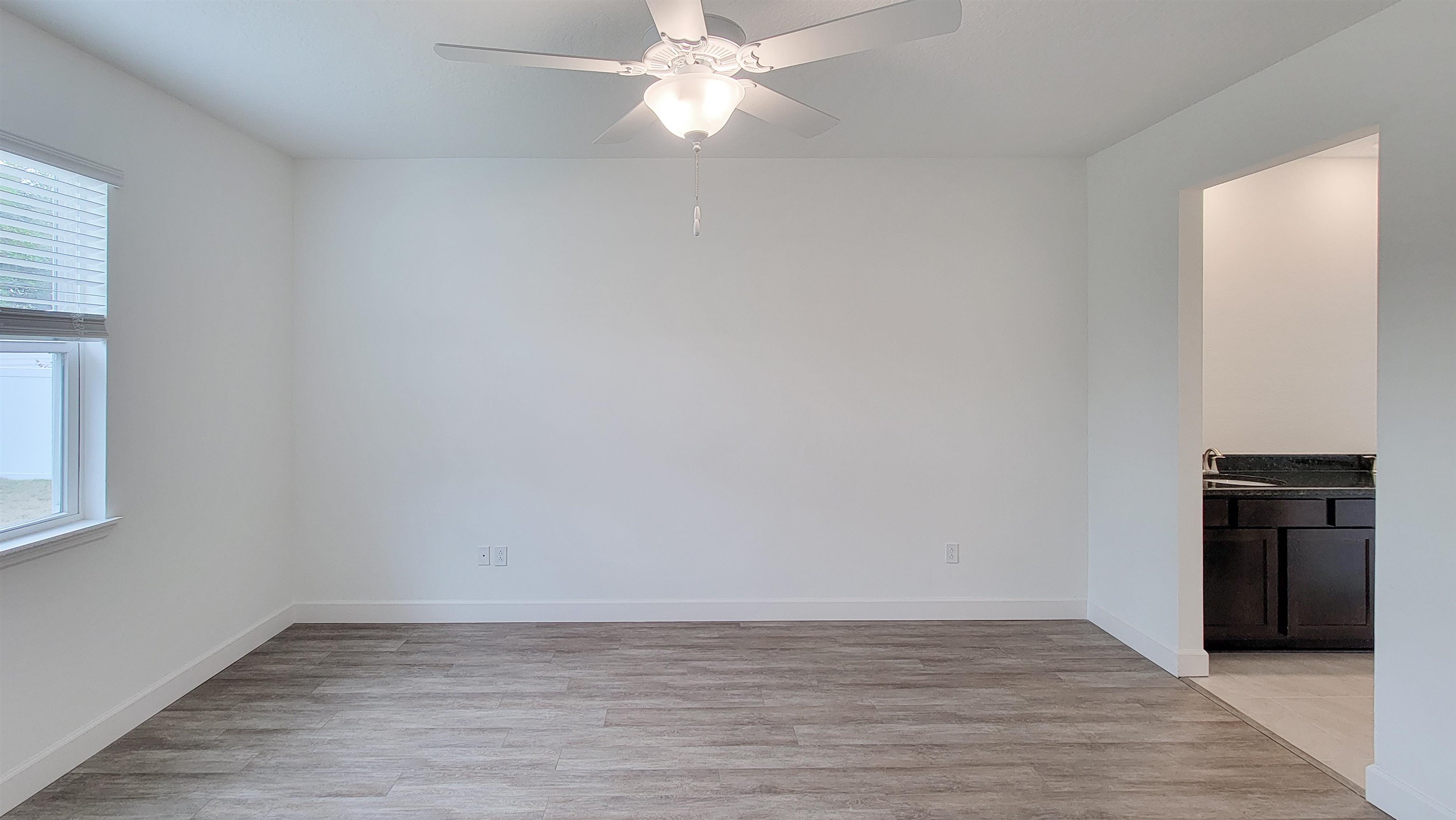 62 Roxboro Drive Palm Coast, FL 32164 - Photo 20 of 35 a view of an empty room with wooden floor and a window