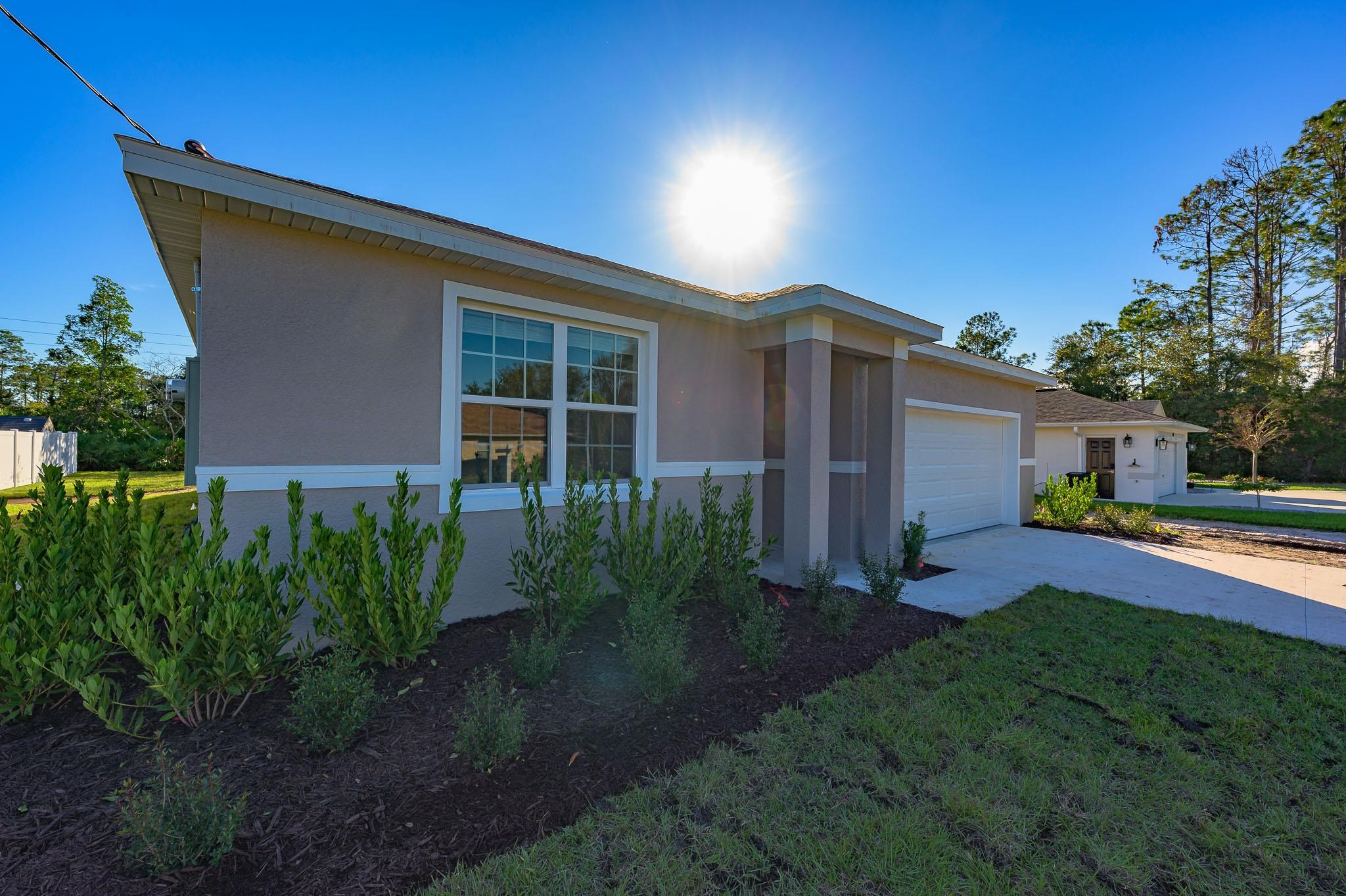 62 Roxboro Drive Palm Coast, FL 32164 - Photo 2 of 35 a front view of house with yard and green space