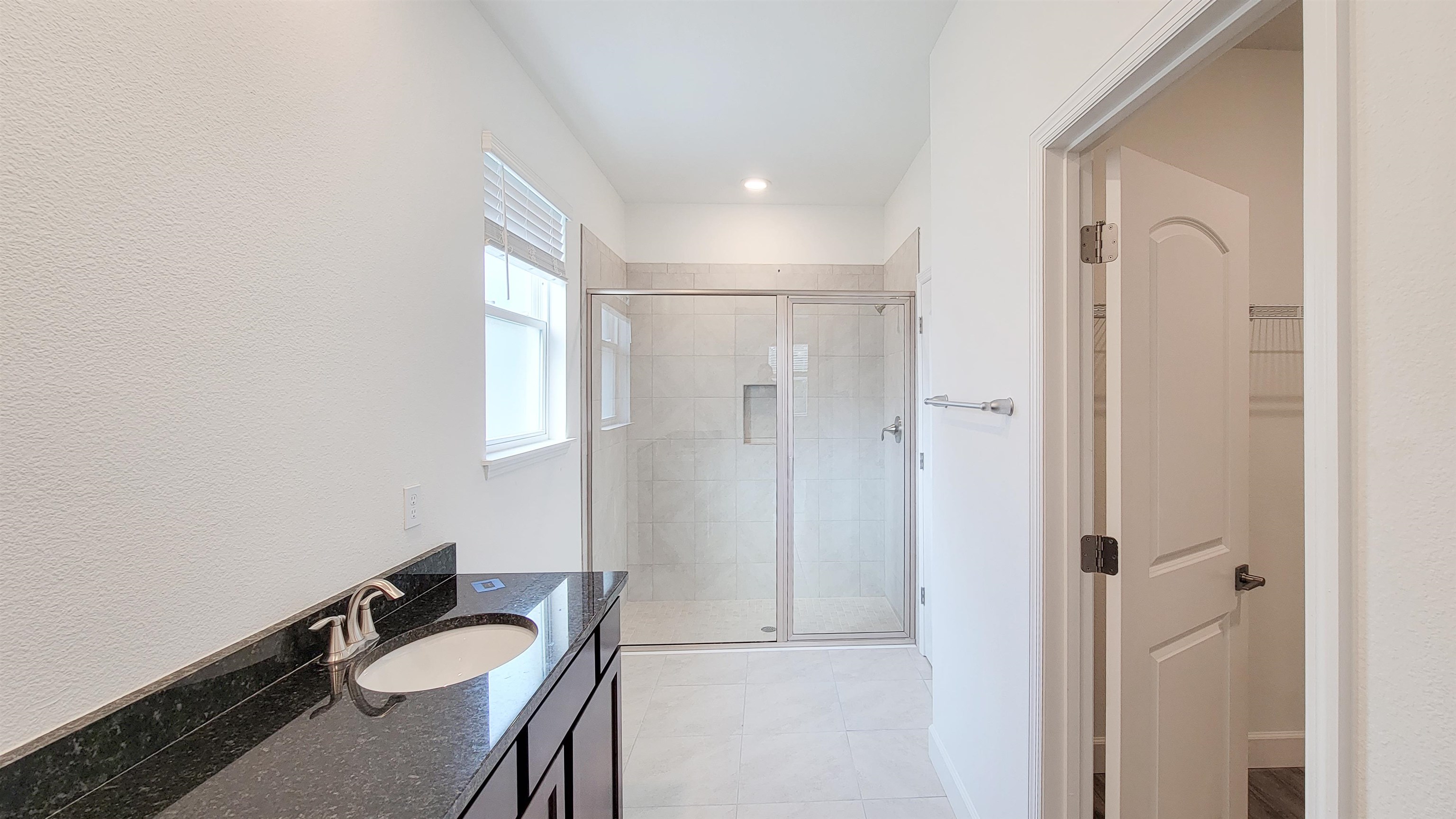 62 Roxboro Drive Palm Coast, FL 32164 - Photo 22 of 35 a bathroom with a granite countertop sink a mirror and a shower
