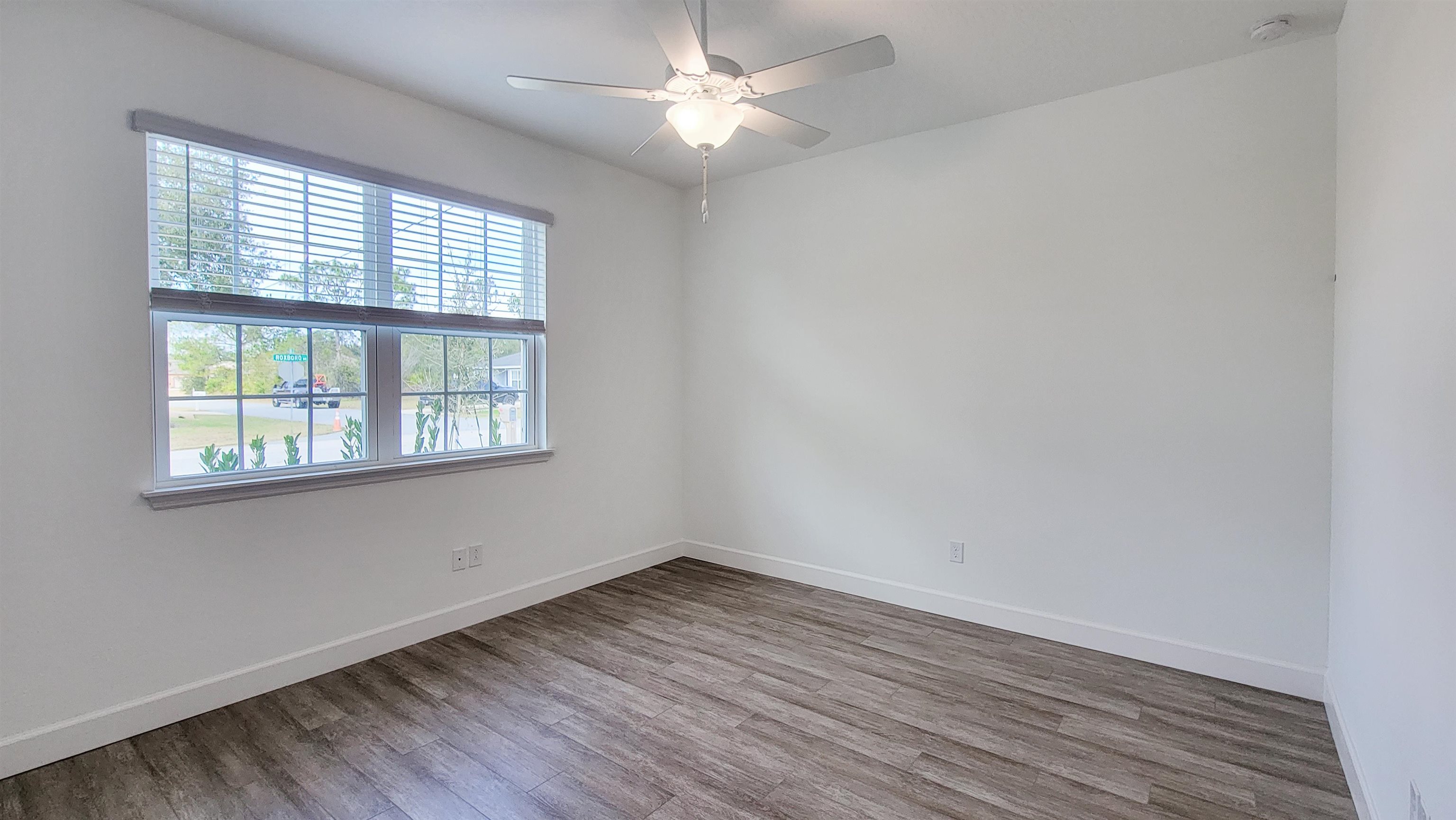 62 Roxboro Drive Palm Coast, FL 32164 - Photo 24 of 35 an empty room with wooden floor and windows
