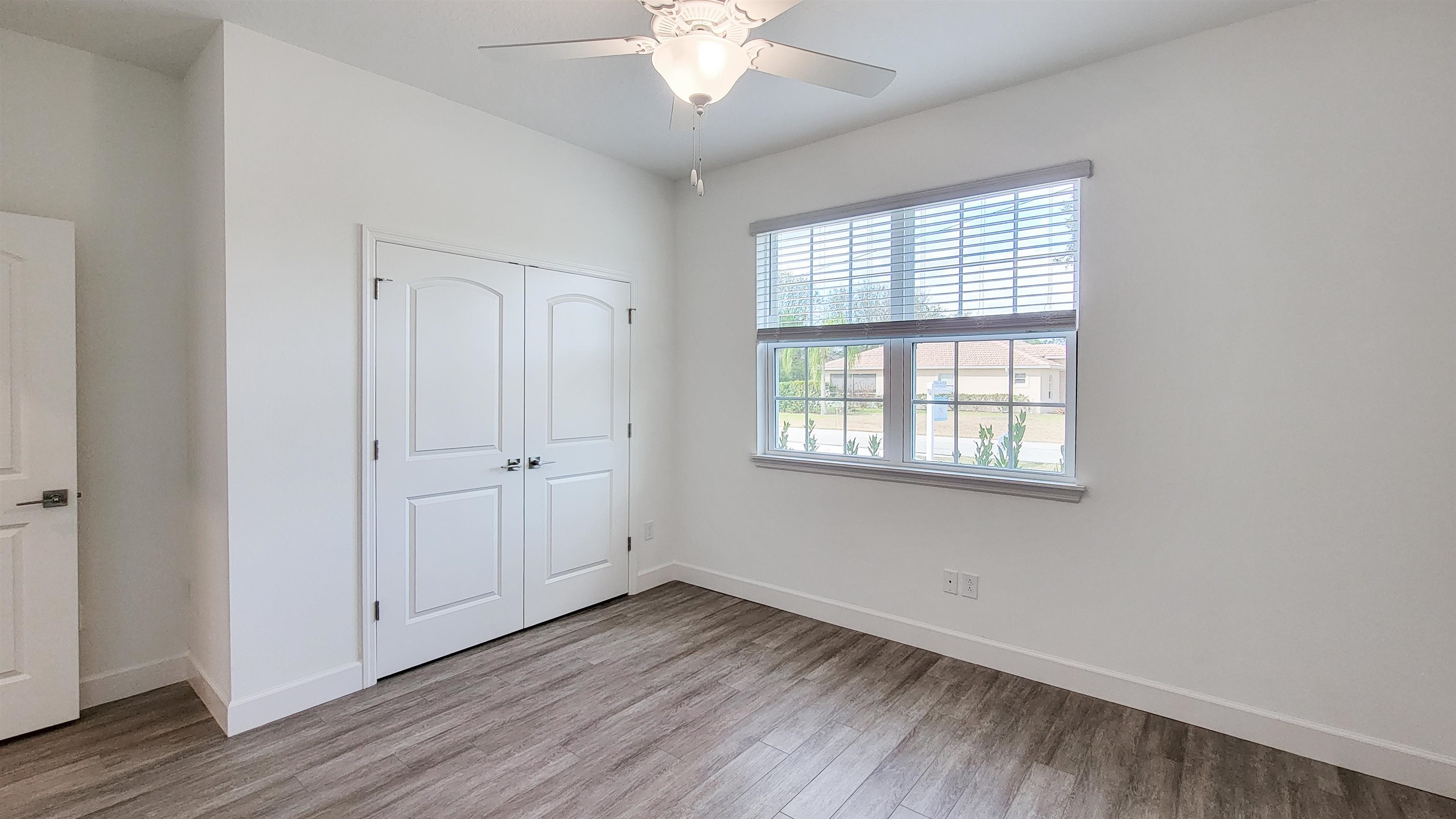 62 Roxboro Drive Palm Coast, FL 32164 - Photo 25 of 35 a view of an empty room with wooden floor and a window
