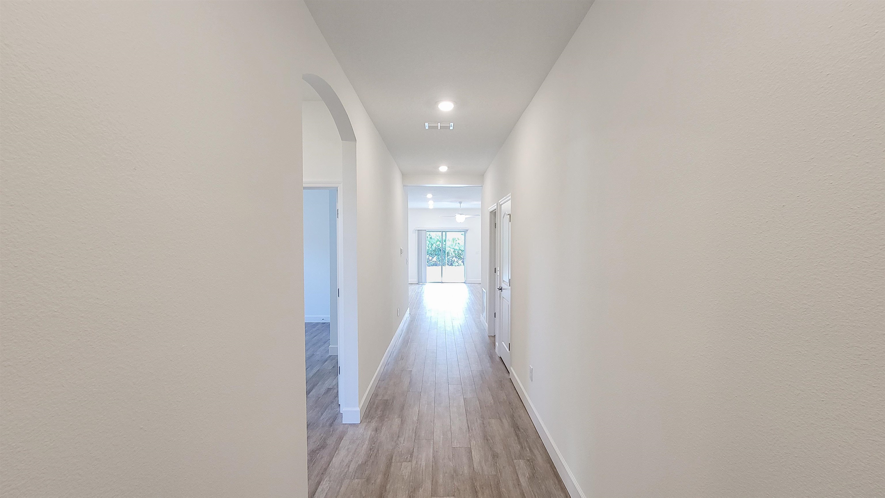 62 Roxboro Drive Palm Coast, FL 32164 - Photo 9 of 35 a view of a hallway with wooden floor