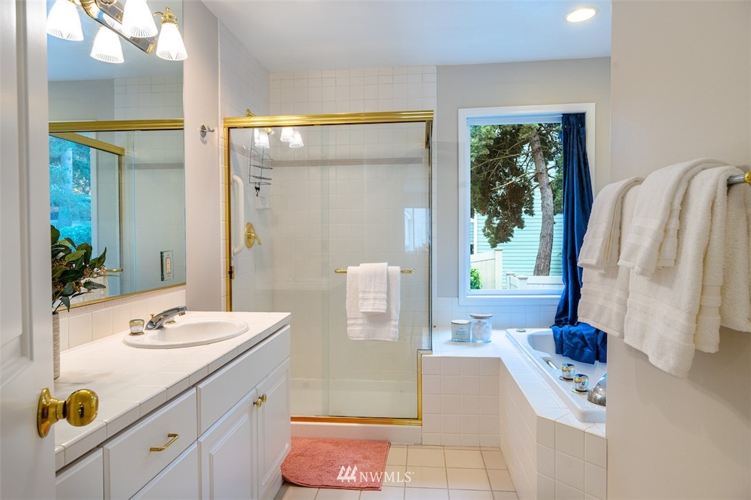 7323 Old Redmond Road, Unit 6 Redmond, WA 98052 - Photo 12 of 18 a bathroom with a sink a mirror and a shower