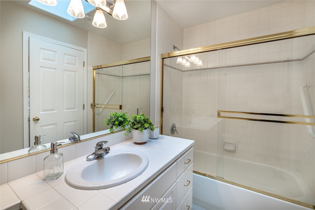 7323 Old Redmond Road, Unit 6 Redmond, WA 98052 - Photo 15 of 18 a bathroom with a sink vanity granite tub shower and a mirror