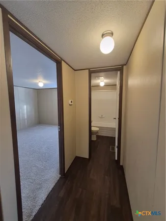a view of hallway with wooden floor