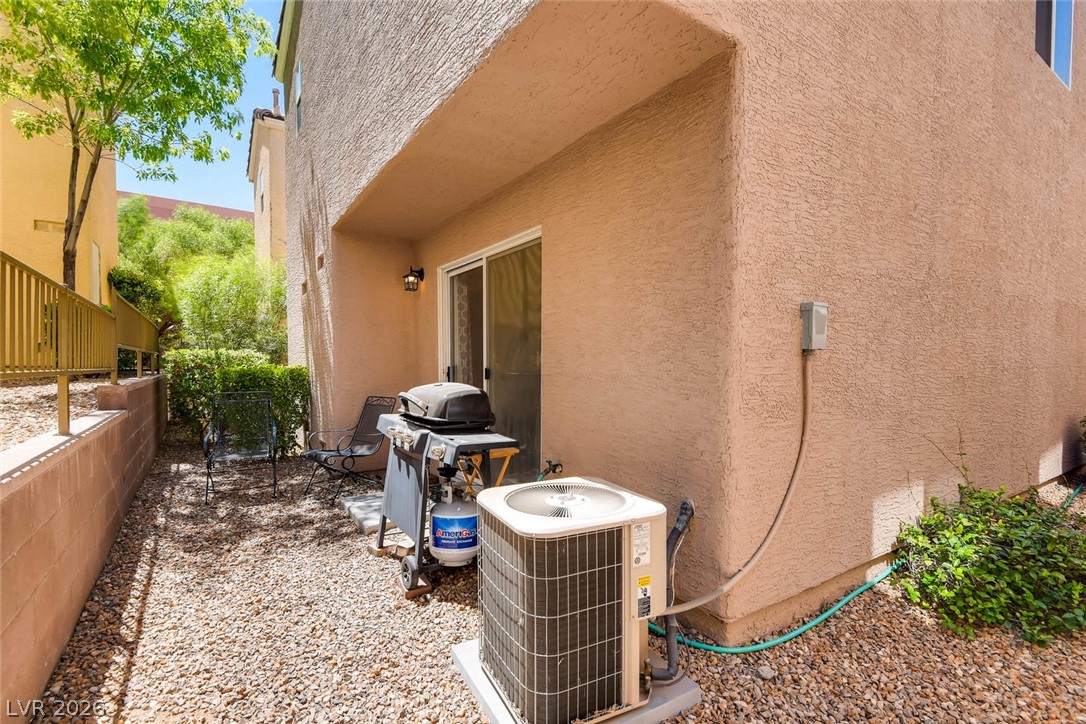 10451 Processor Court Las Vegas, NV 89129 - Photo 25 of 28 A private, gravel-covered patio awaits with ample space for outdoor grilling and relaxation.