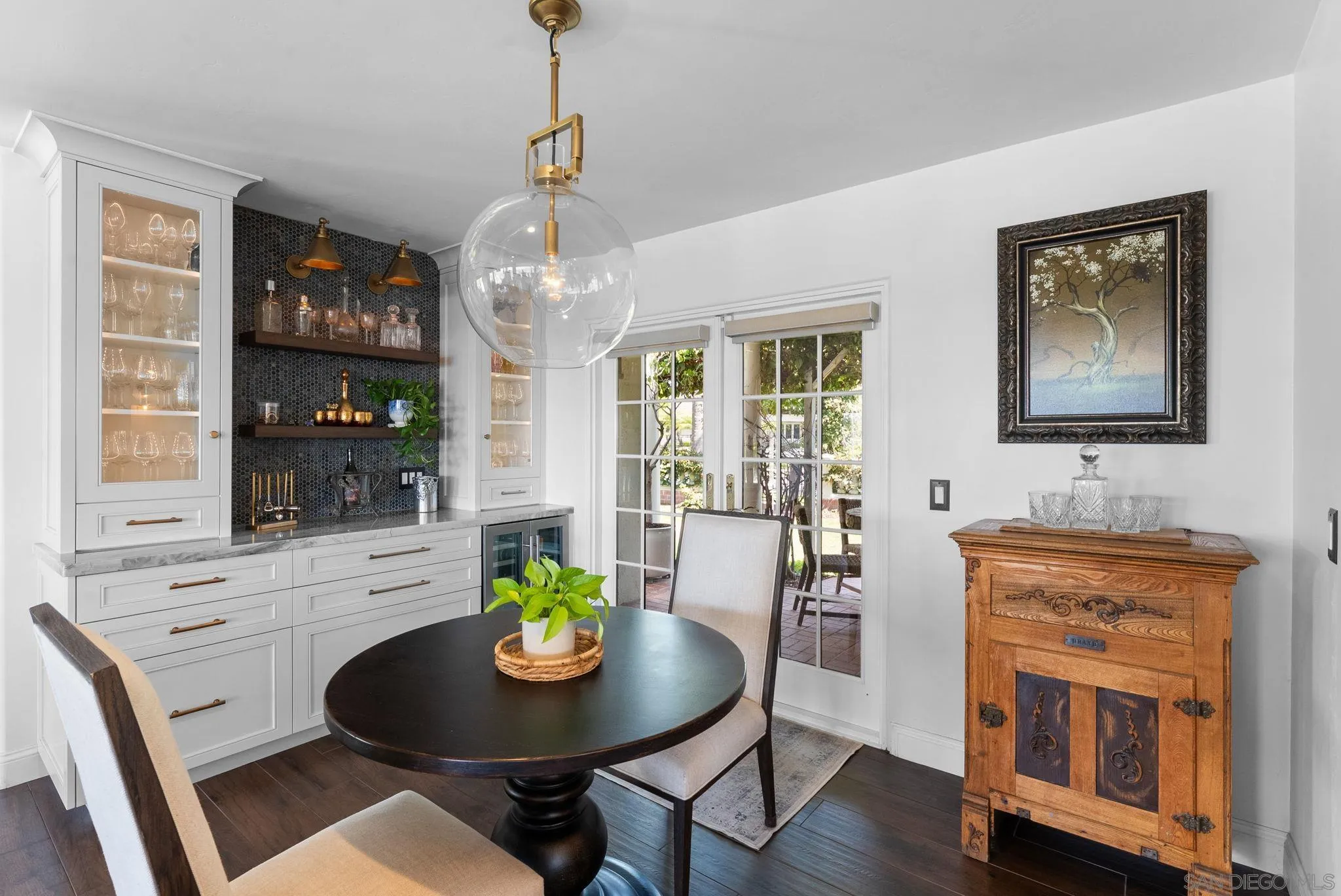 4136 Palisades Road San Diego, CA 92116 - Photo 22 of 68 a view of a dining room with furniture a chandelier and wooden floor