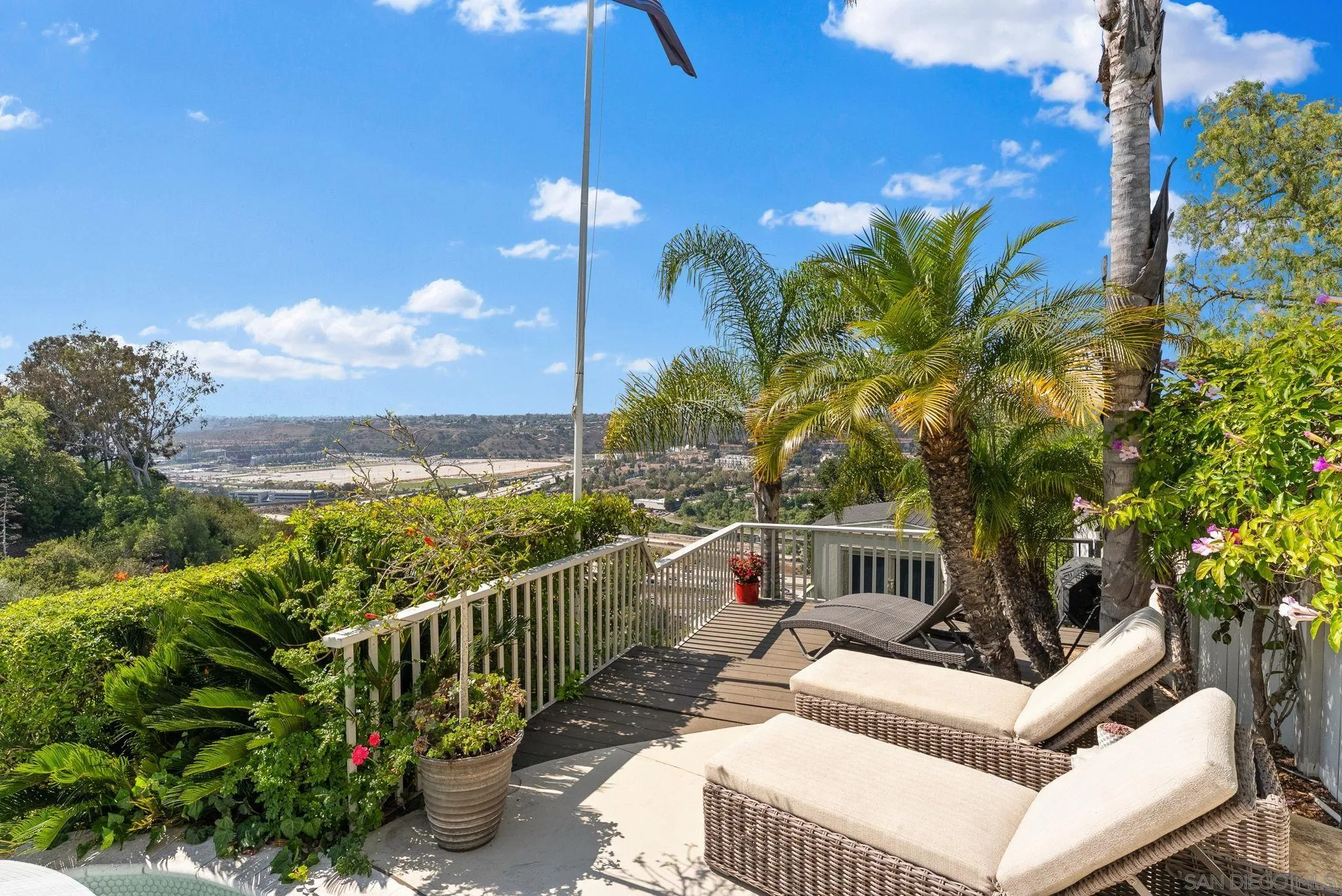 4136 Palisades Road San Diego, CA 92116 - Photo 48 of 68 a view of a balcony with floor to ceiling window and potted plants
