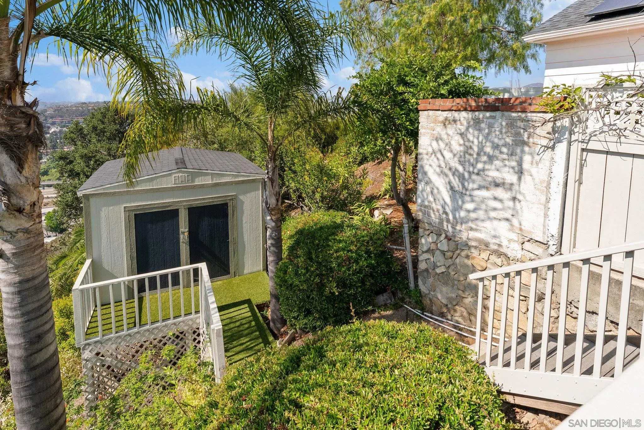 4136 Palisades Road San Diego, CA 92116 - Photo 49 of 68 a view of a house with a large window and flower plants