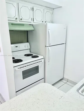 a white stove top oven sitting inside of a kitchen