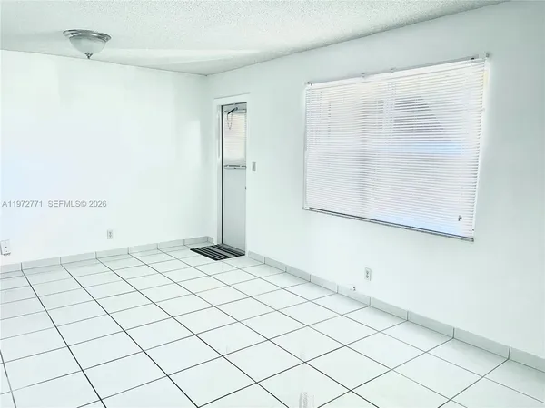 a white toilet sitting next to a bath tub and a shower