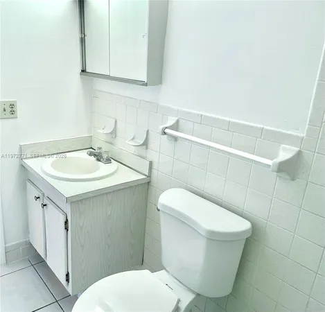 a bathroom with a sink toilet and mirror