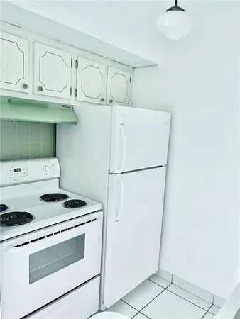 a kitchen with cabinets and white appliances