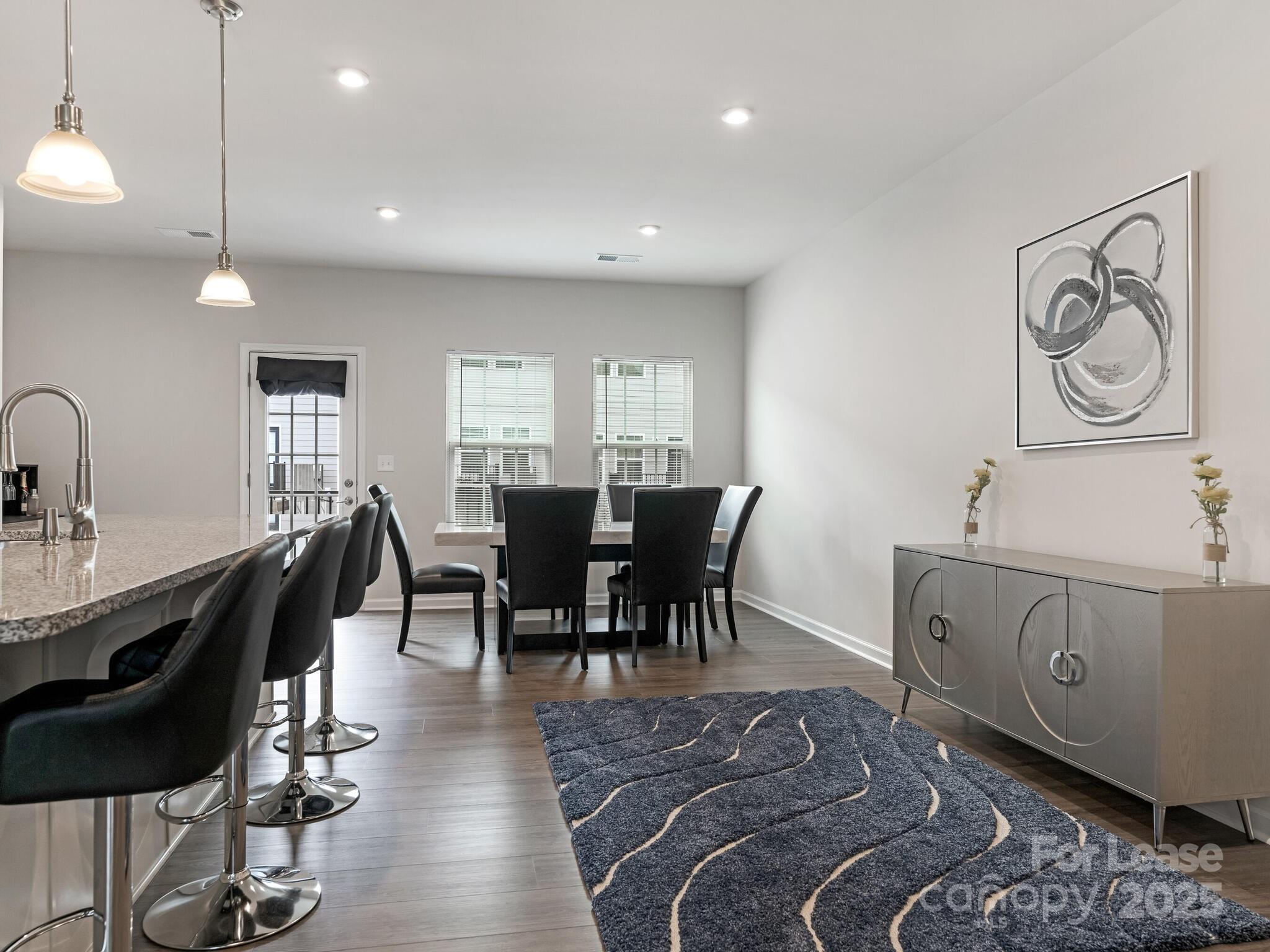 1409 May Apple Drive Matthews, NC 28104 - Photo 11 of 28 a view of a a dining room with furniture window and wooden floor