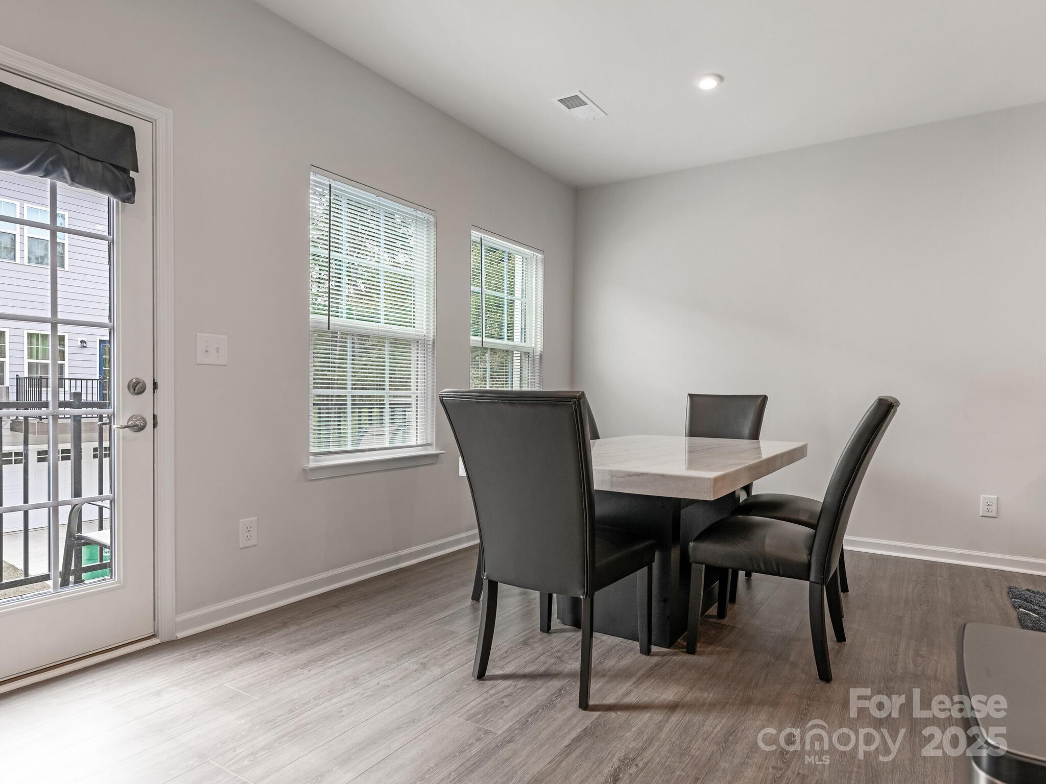 1409 May Apple Drive Matthews, NC 28104 - Photo 12 of 28 a view of a dining room with furniture window and outside view
