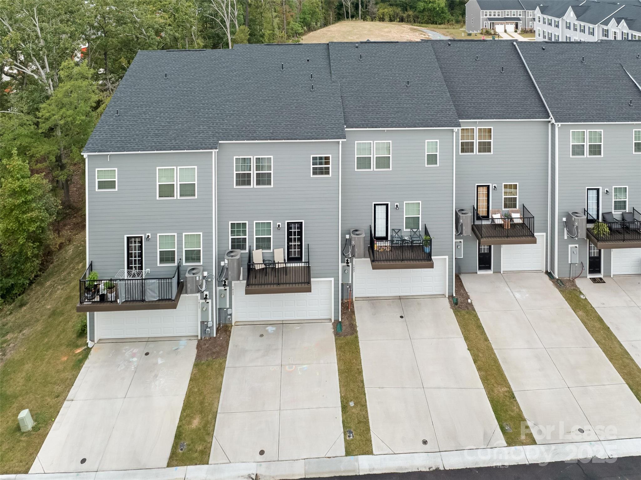 1409 May Apple Drive Matthews, NC 28104 - Photo 24 of 28 a view of a patio with couches table and chairs under an umbrella