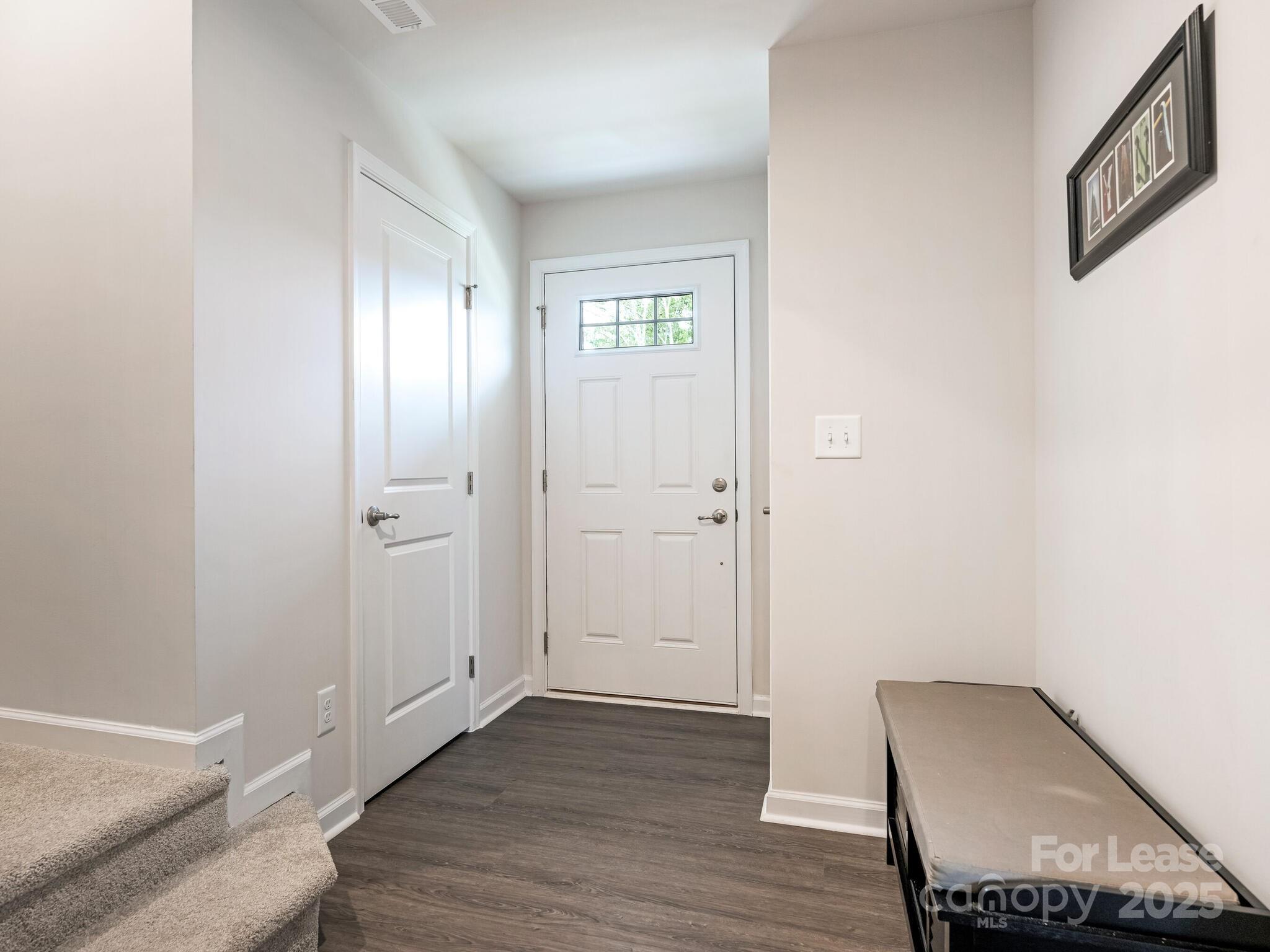1409 May Apple Drive Matthews, NC 28104 - Photo 3 of 28 an empty room with wooden floor and windows