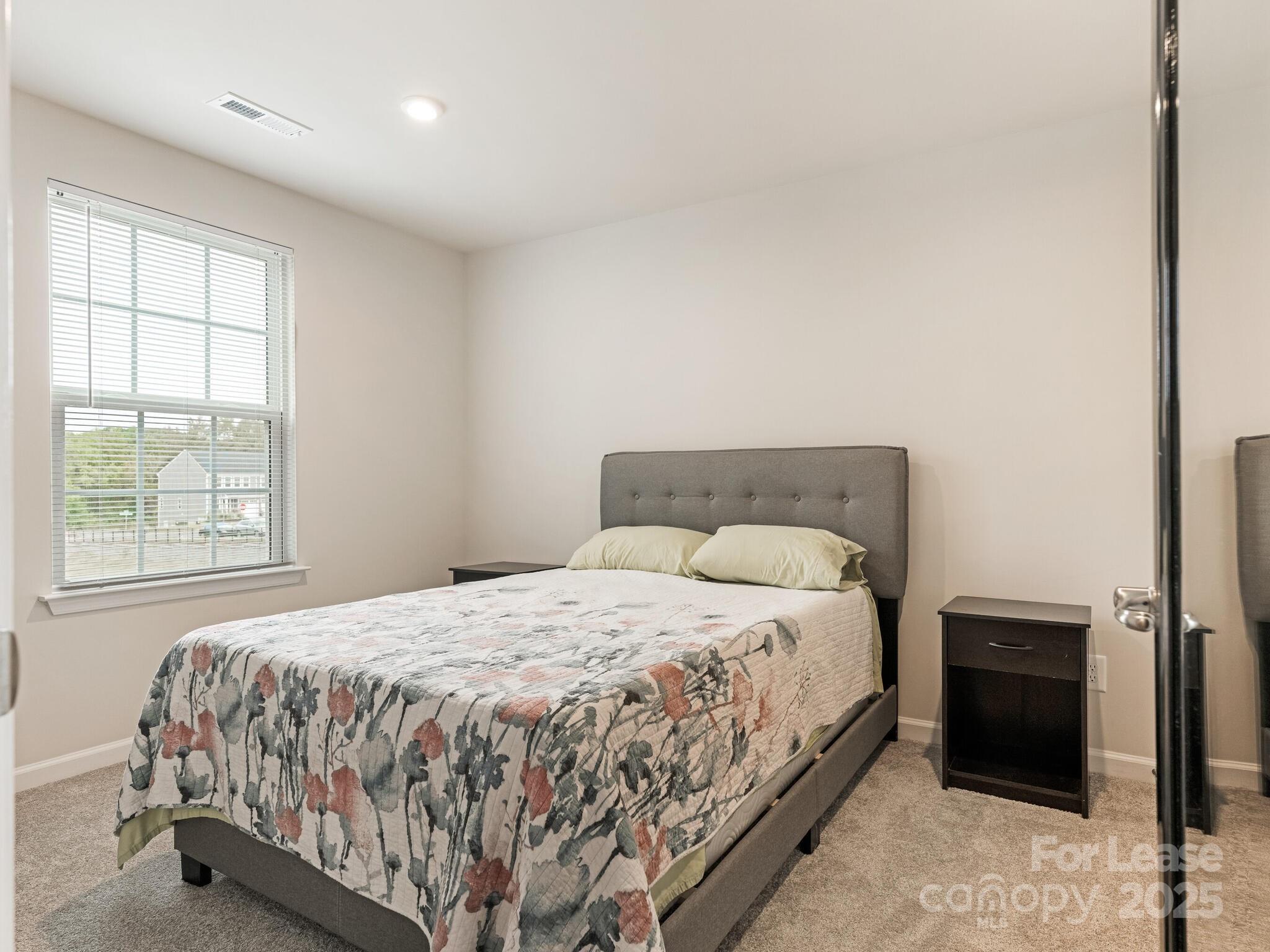 1409 May Apple Drive Matthews, NC 28104 - Photo 4 of 28 a bedroom with a bed and a window