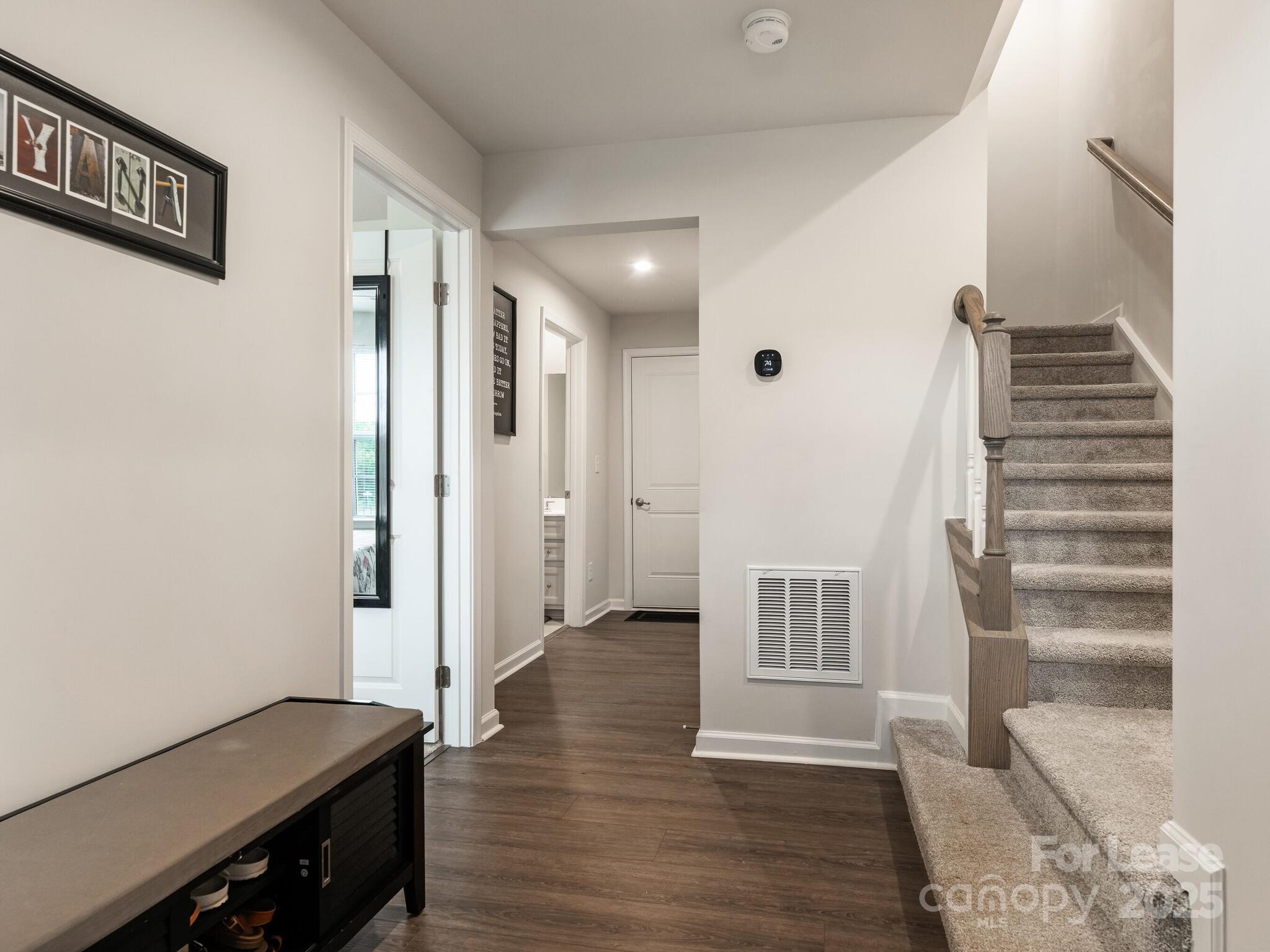 1409 May Apple Drive Matthews, NC 28104 - Photo 6 of 28 a view of a hallway with wooden floor and entryway