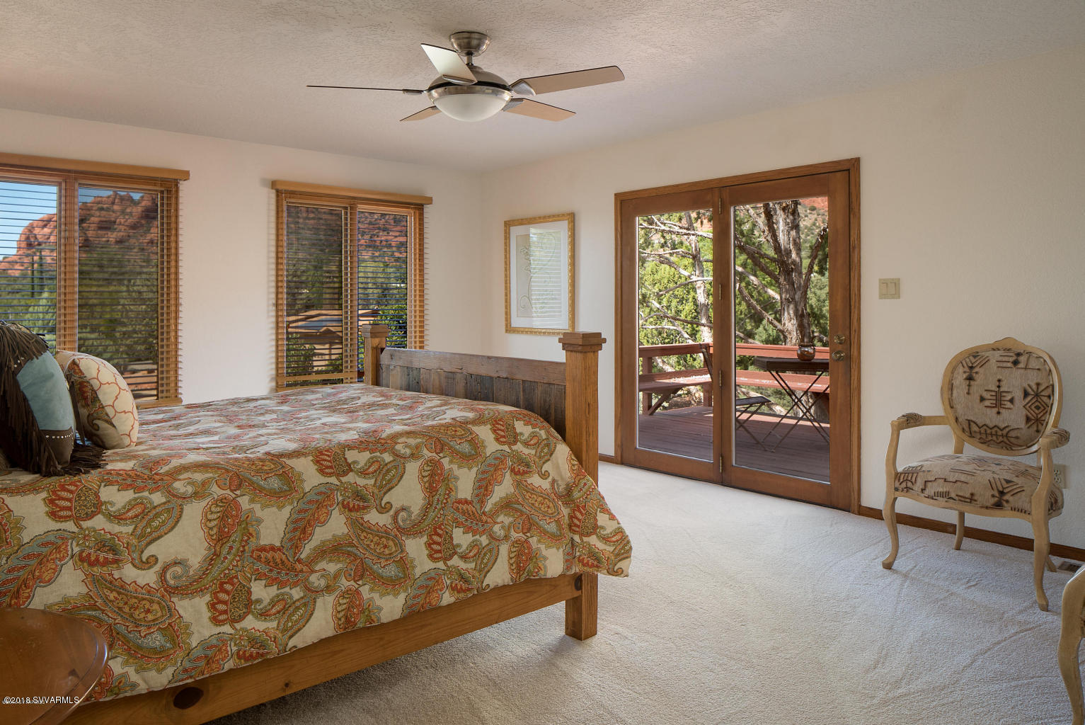 2450 Homestead Road Sedona, AZ 86336 - Photo 15 of 25 a spacious bedroom with a bed a table and large window