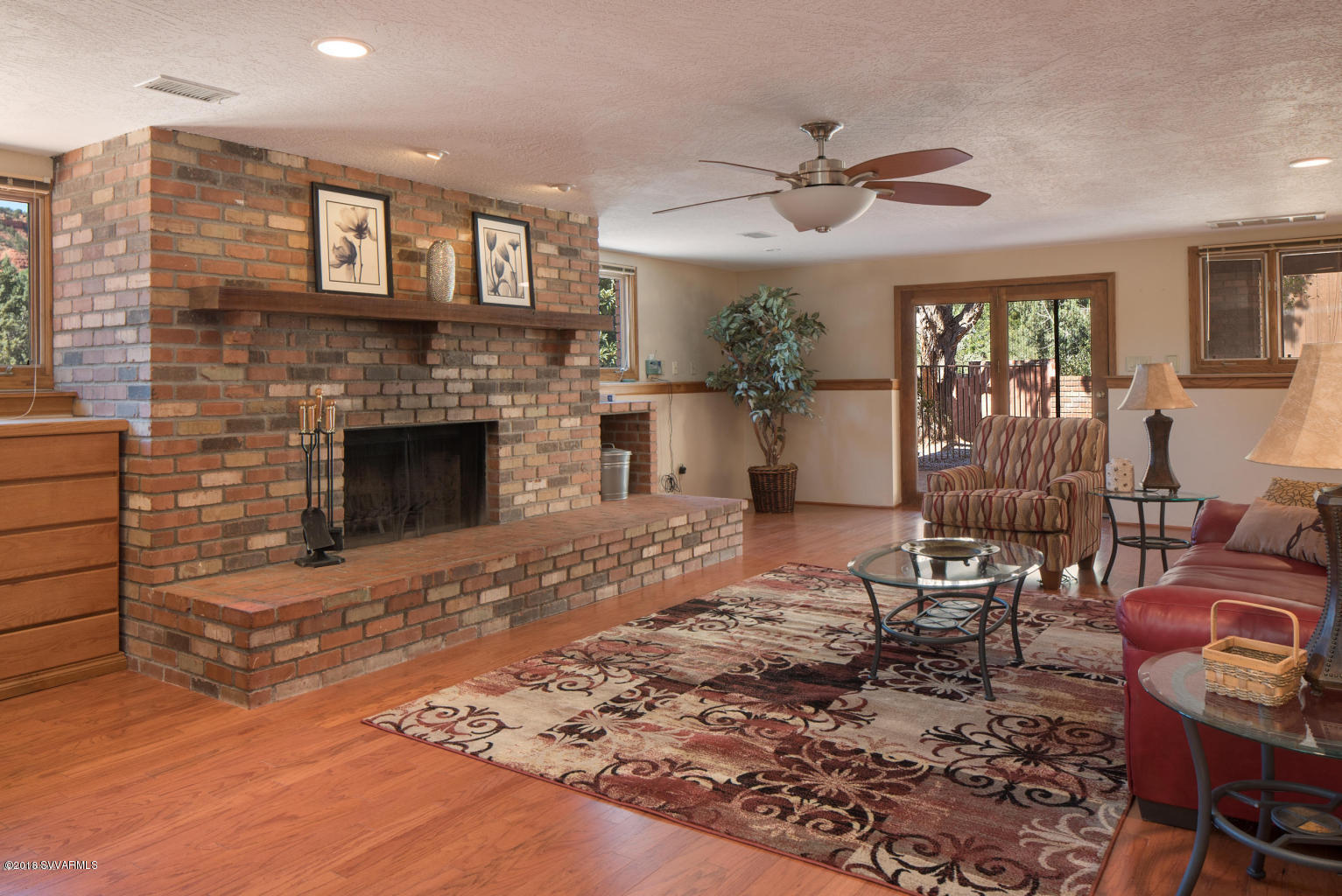 2450 Homestead Road Sedona, AZ 86336 - Photo 20 of 25 a living room with furniture and a fireplace