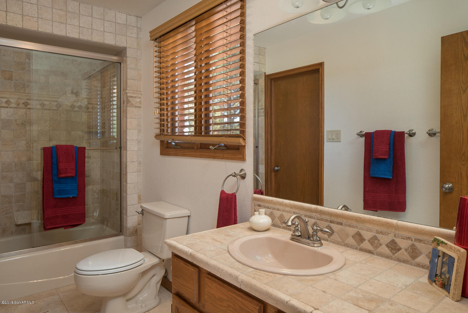 2450 Homestead Road Sedona, AZ 86336 - Photo 23 of 25 a bathroom with a granite countertop toilet sink and mirror