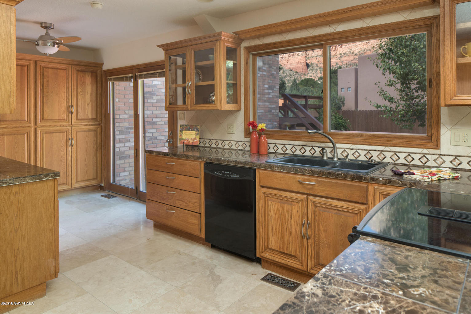 2450 Homestead Road Sedona, AZ 86336 - Photo 9 of 25 a kitchen with granite countertop a refrigerator and a sink