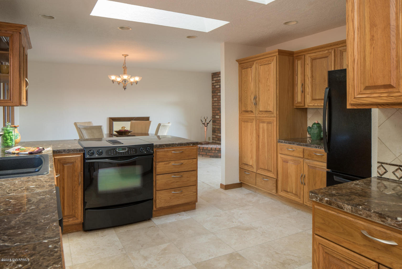 2450 Homestead Road Sedona, AZ 86336 - Photo 10 of 25 a kitchen with stainless steel appliances granite countertop a stove and a refrigerator