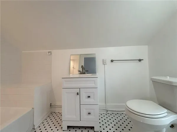 a bathroom with a toilet a sink and shower