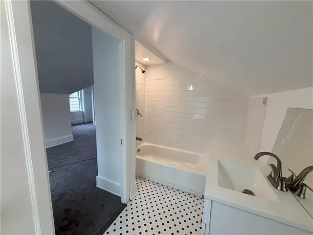 a bathroom with a bathtub and a shower