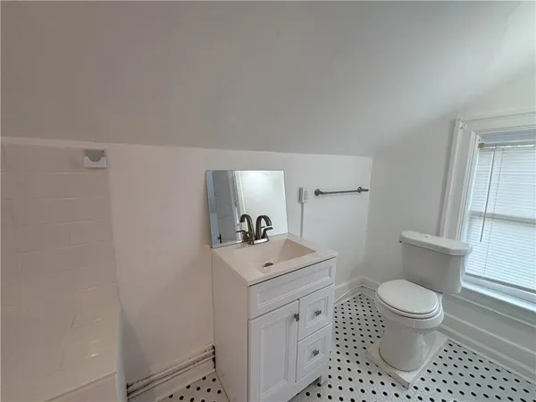 a bathroom with a sink a toilet and a mirror