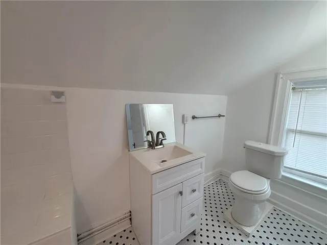 a bathroom with a sink a toilet and a mirror