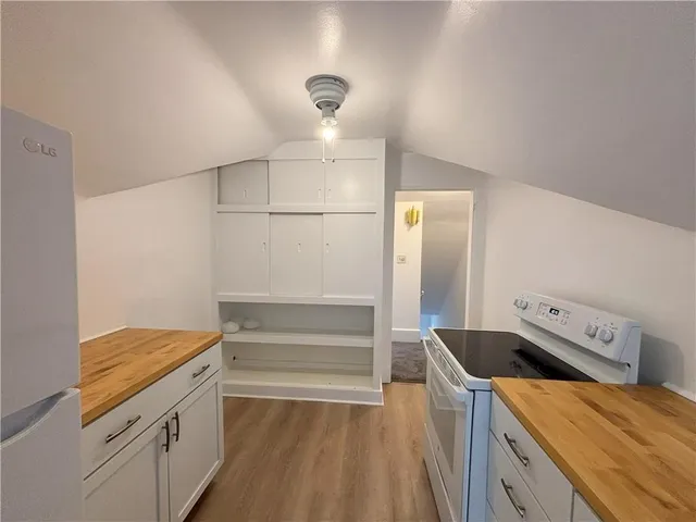a kitchen that has a microwave a stove and a refrigerator