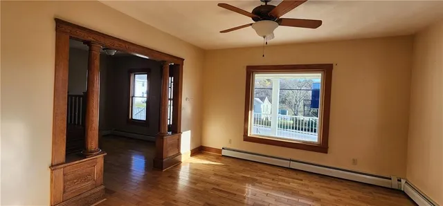 a view of an entryway with wooden floor and a window