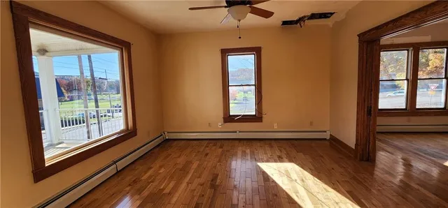 wooden floor in an empty room with a window