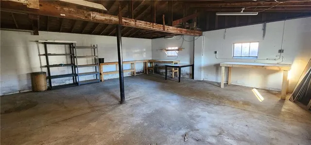 a view of a room with table and chairs