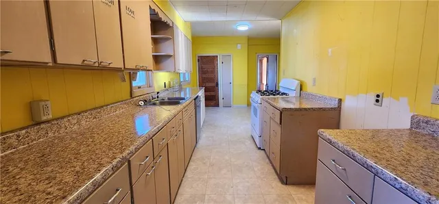 a kitchen with sink cabinets and stove