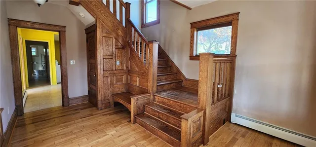 a view of entryway and hall with wooden floor
