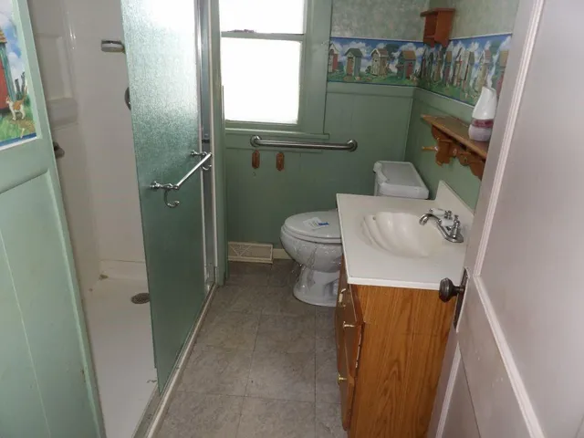 a bathroom with a toilet and a shower