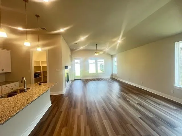 a view of a room with wooden floor and outdoor space