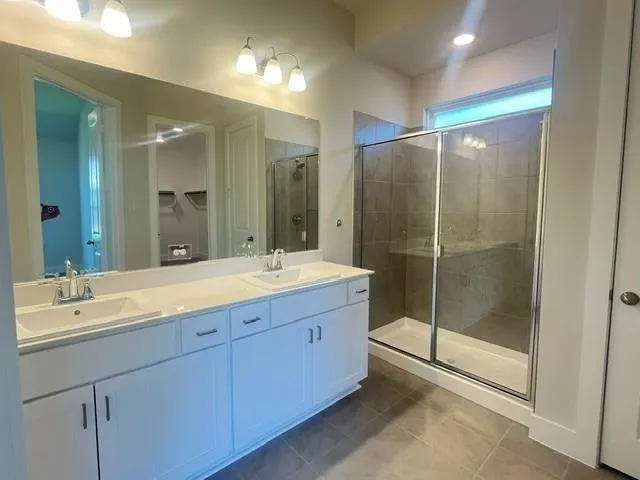 a bathroom with double sink and a mirror