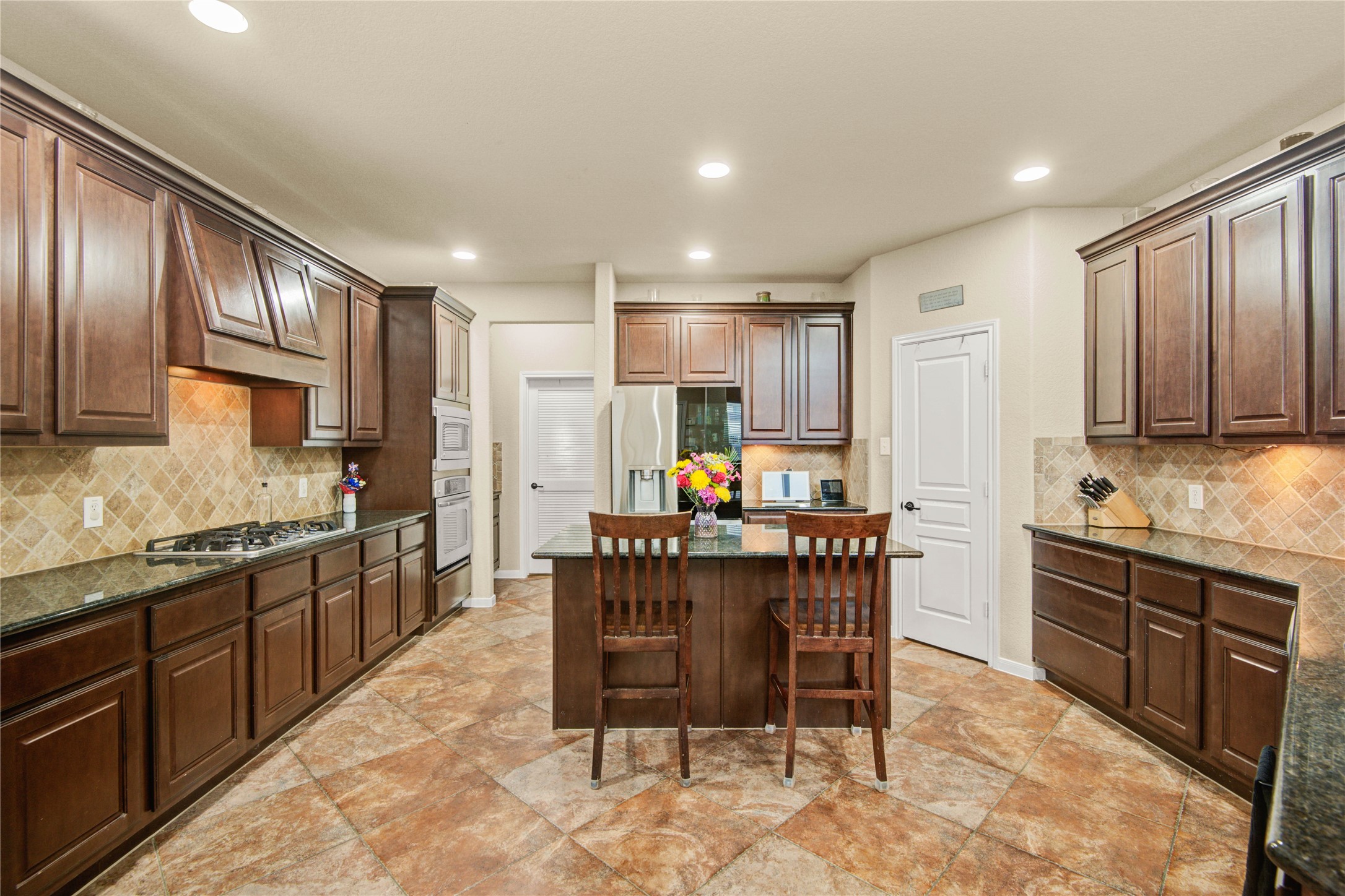 6007 Valhalla Drive Spring, TX 77379 - Photo 11 of 37 From the sunny breakfast area, the kitchen showcases rich cabinetry, extensive counter space, and a functional layout for everyday living.
