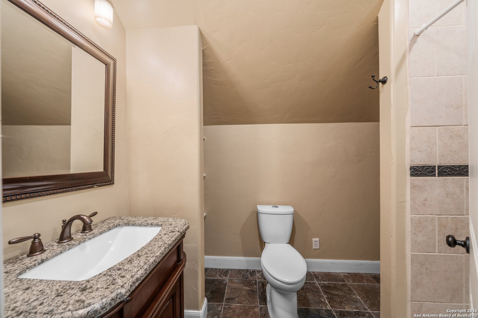 130 Rhum Road Kerrville, TX 78028 - Photo 15 of 31 a bathroom with a granite countertop toilet a sink and a mirror