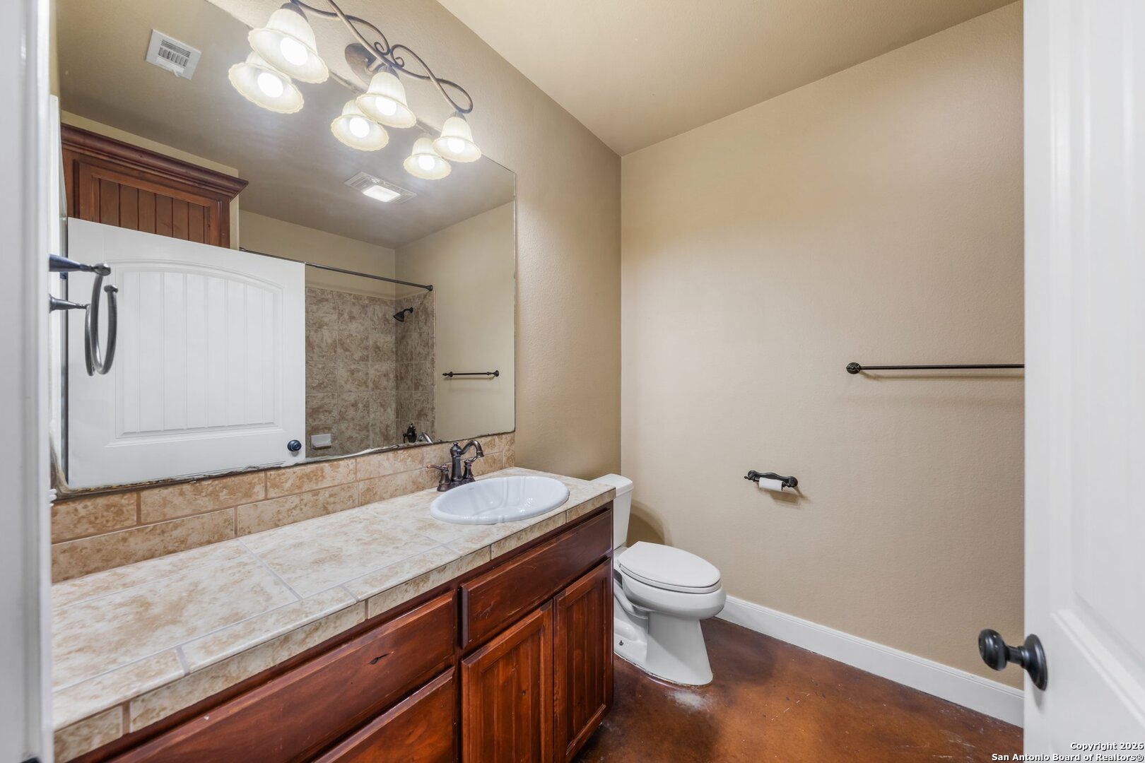 130 Rhum Road Kerrville, TX 78028 - Photo 17 of 31 a bathroom with a granite countertop sink a toilet and a mirror