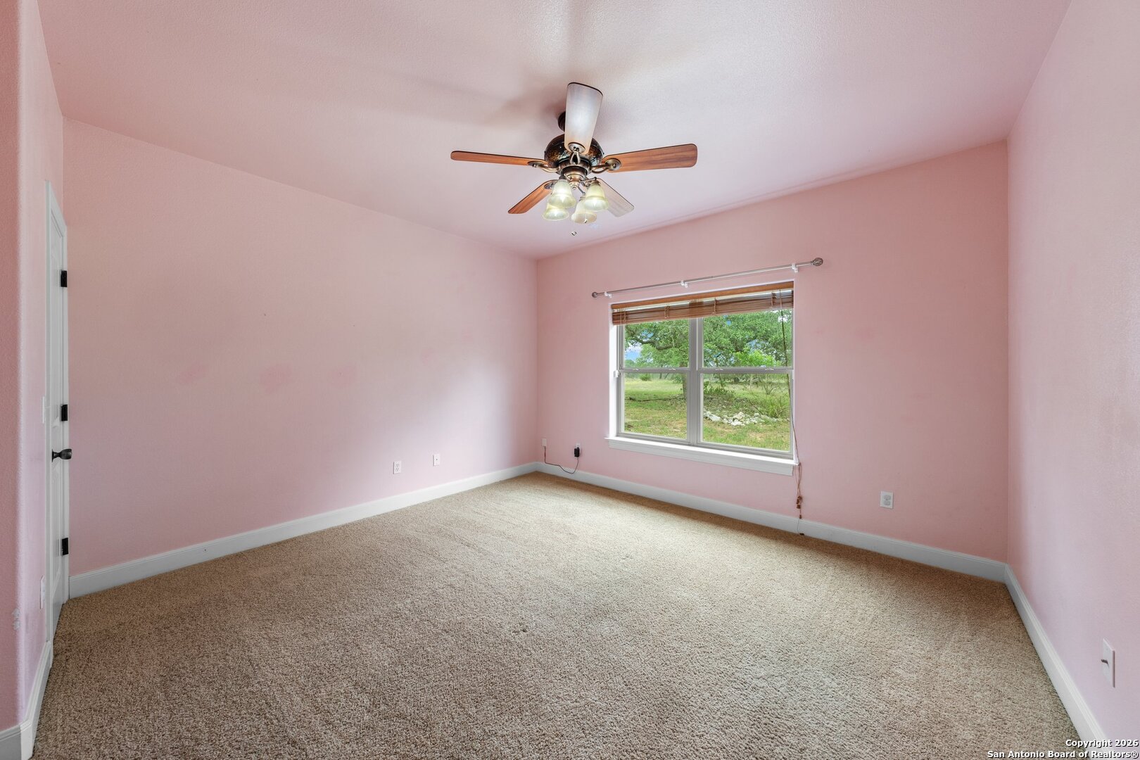 130 Rhum Road Kerrville, TX 78028 - Photo 20 of 31 an empty room with a window and a fan