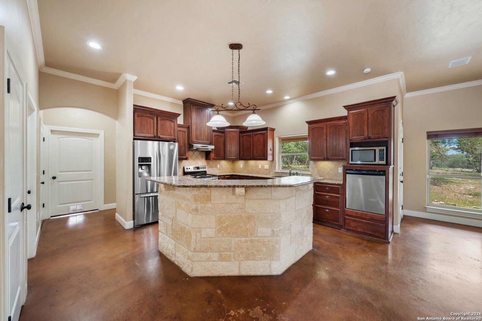 130 Rhum Road Kerrville, TX 78028 - Photo 6 of 31 a large kitchen with stainless steel appliances kitchen island granite countertop a stove top oven a refrigerator and a view of living room