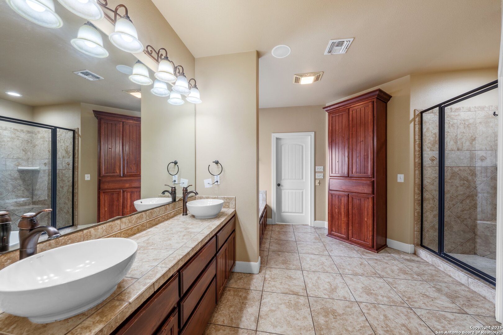 130 Rhum Road Kerrville, TX 78028 - Photo 10 of 31 a spacious bathroom with a granite countertop sink a mirror and a shower